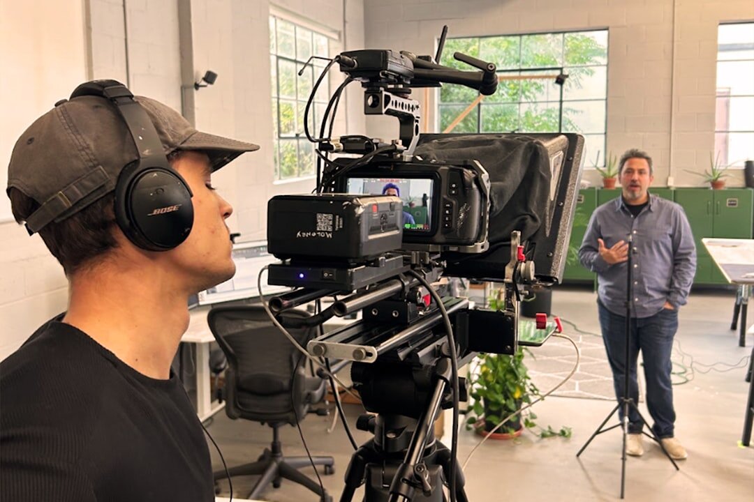 Studio interview setup with camera filming a speaker on a set
